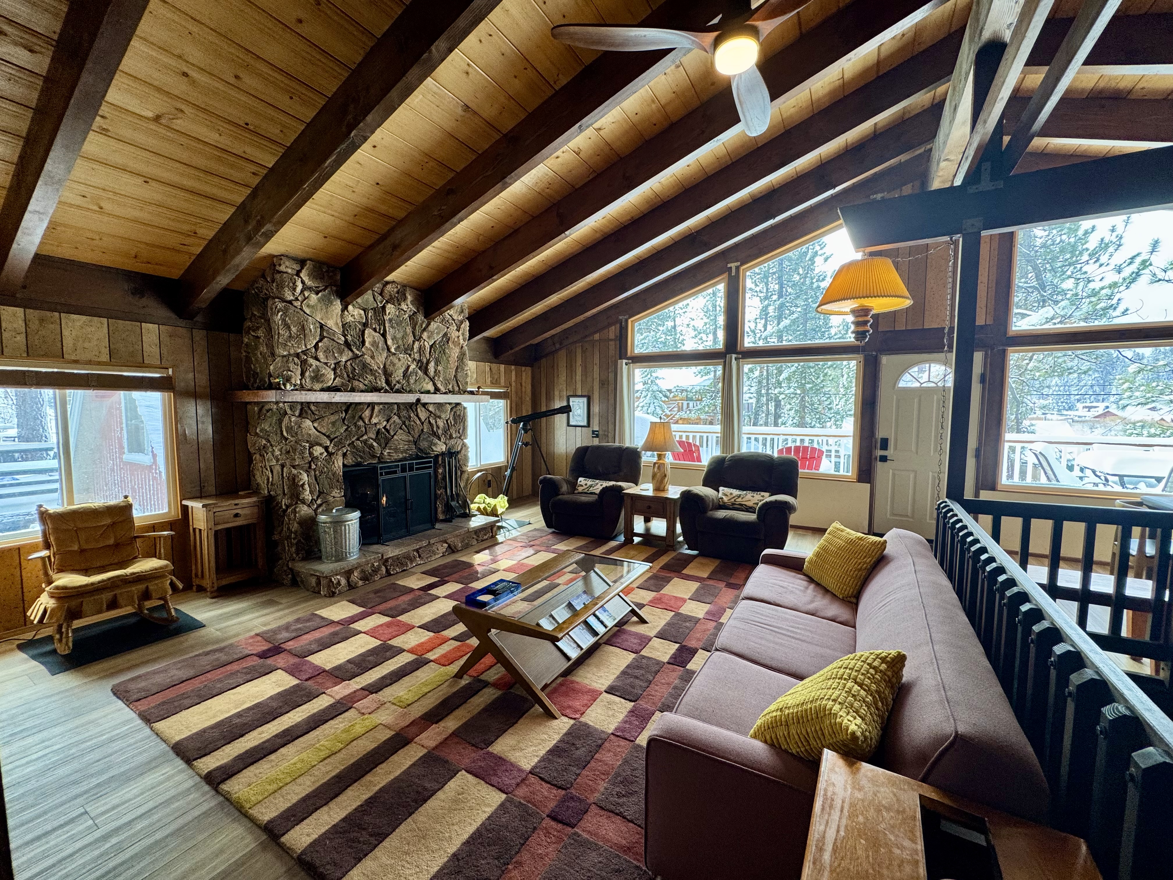 Living room with stone fireplace at Bear View Escape in Big Bear Lake