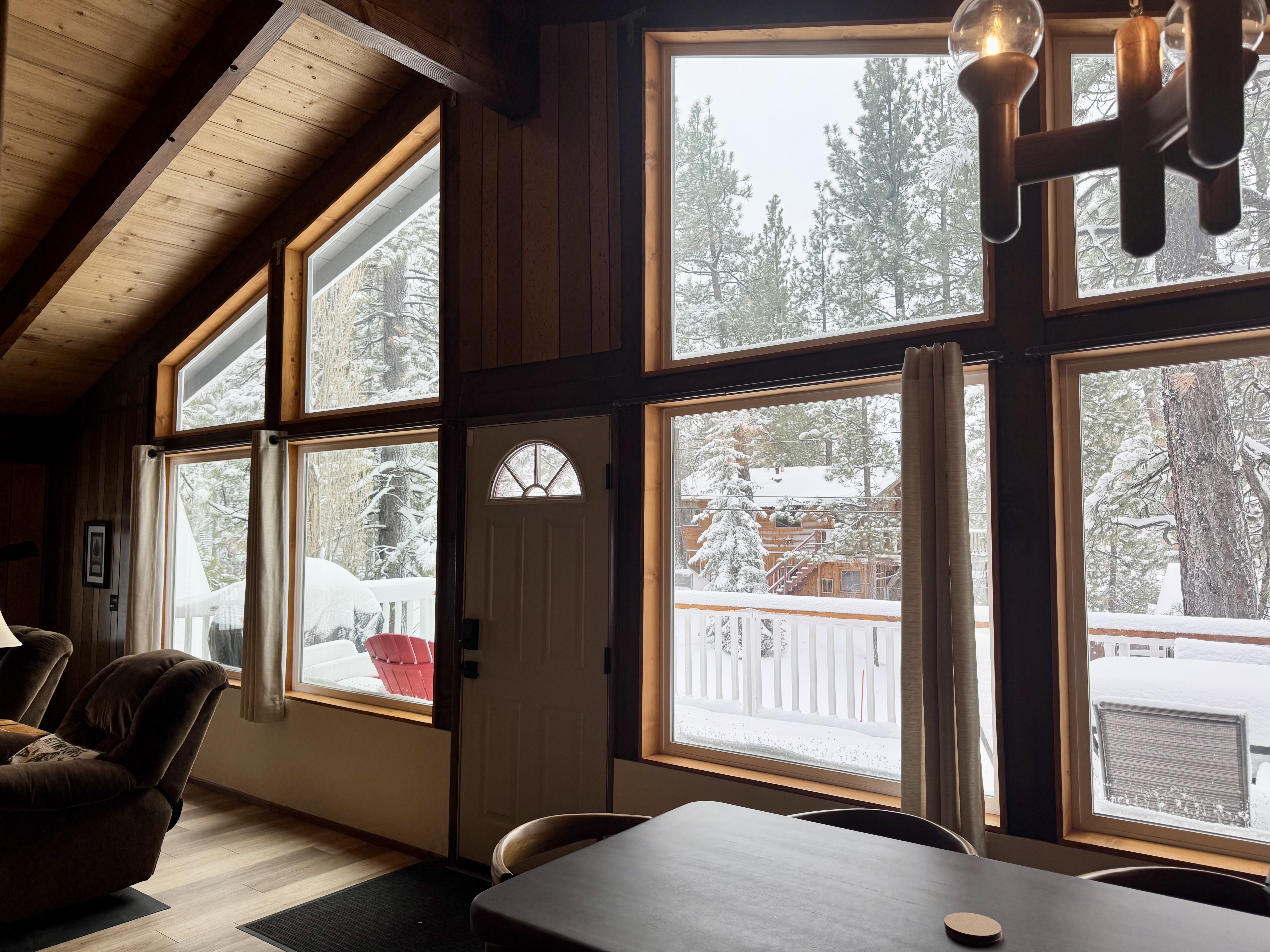 Dining area with large windows and mountain and forest views at Bear View Escape in Big Bear Lake